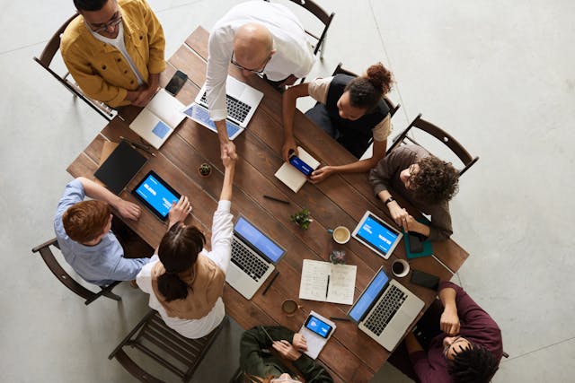 a group of employees sitting at a table during a meeting