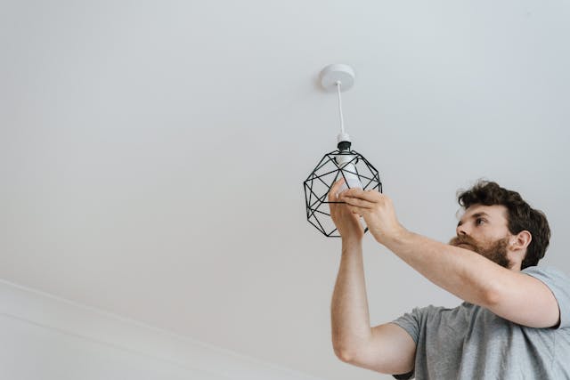 a person changing a lightbulb